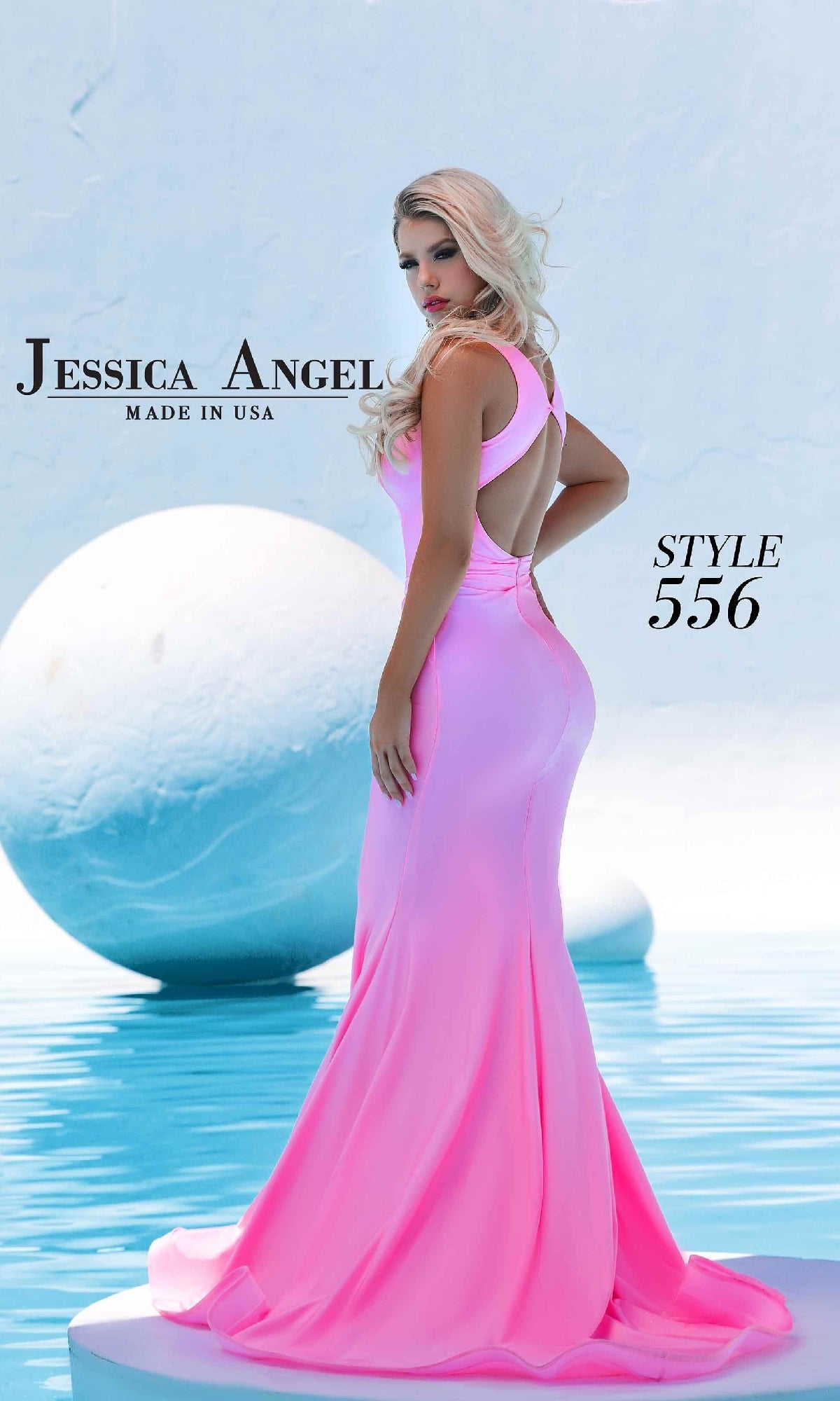 A woman in a bright pink Plunging V-Neck Long Prom Dress, Jessica Angel 556, stands by reflective water with large white spheres. Text reads “Jessica Angel Made in USA, Style 556.”.